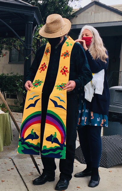 Dr Karen McReynolds, Mark’s spouse, presents stole, one of four gifts from the congregation—a staff, a small communion set for outdoor worship services, binoculars for vision, and this stole to symbolize Mark’s witness. -- David Augsburger